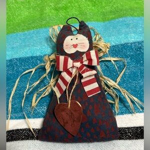 Cute cat angel with raffia wings and metal halo.